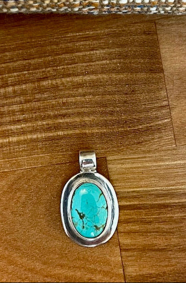 Handcrafted oval turquoise pendant set in sterling silver
