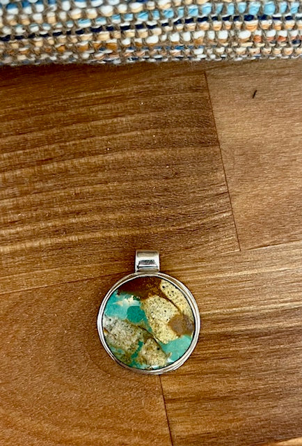 Handcrafted round turquoilse pendant set in sterling silver