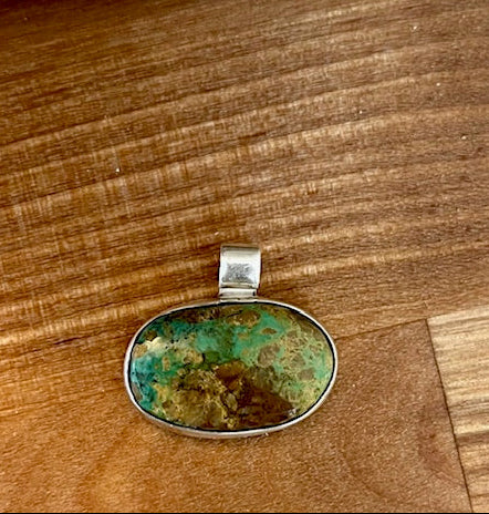 Handcrafted oval turquoise pendant set in sterling silver