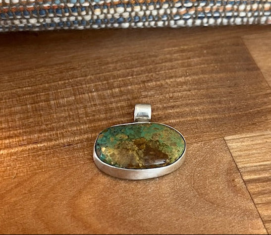 Handcrafted oval turquoise pendant set in sterling silver