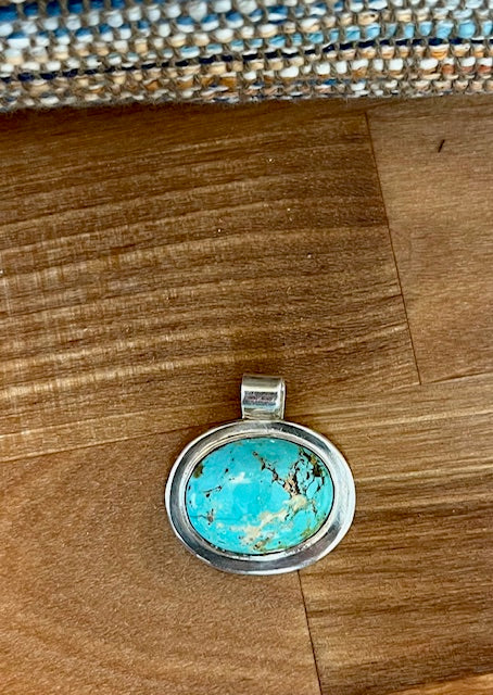 Handcrafted oval turquoise pendant set in sterling silver
