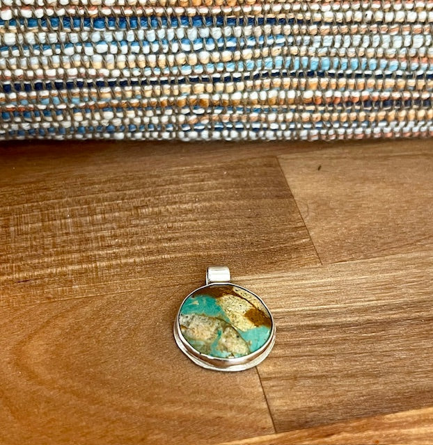 Handcrafted round turquoilse pendant set in sterling silver
