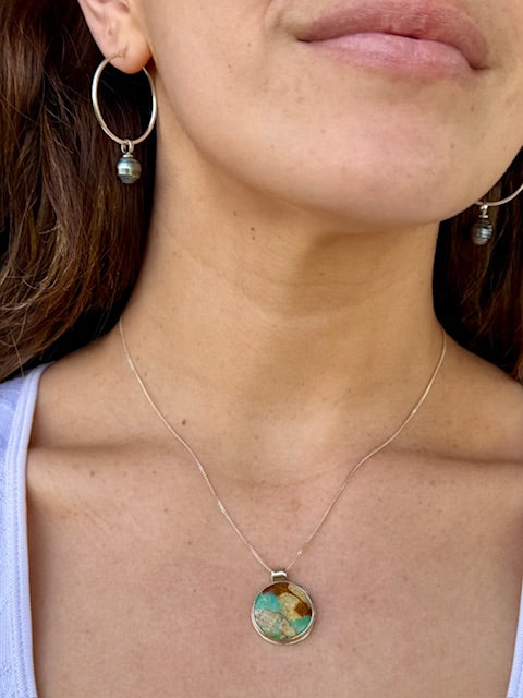 Handcrafted round turquoilse pendant set in sterling silver