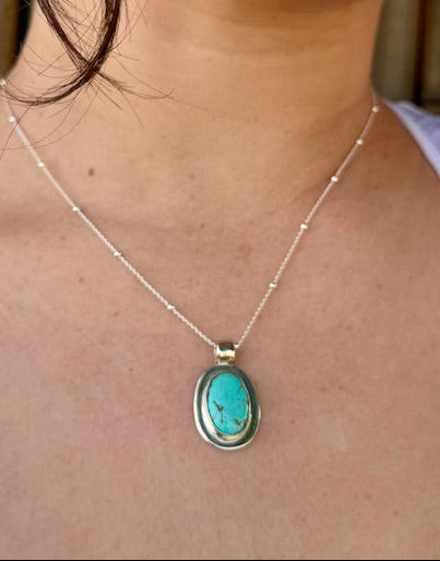 Handcrafted oval turquoise pendant set in sterling silver