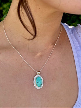 Handcrafted oval turquoise pendant set in sterling silver