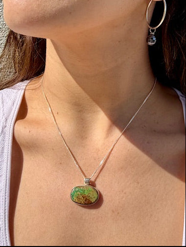 Handcrafted oval turquoise pendant set in sterling silver