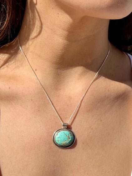 Handcrafted oval turquoise pendant set in sterling silver